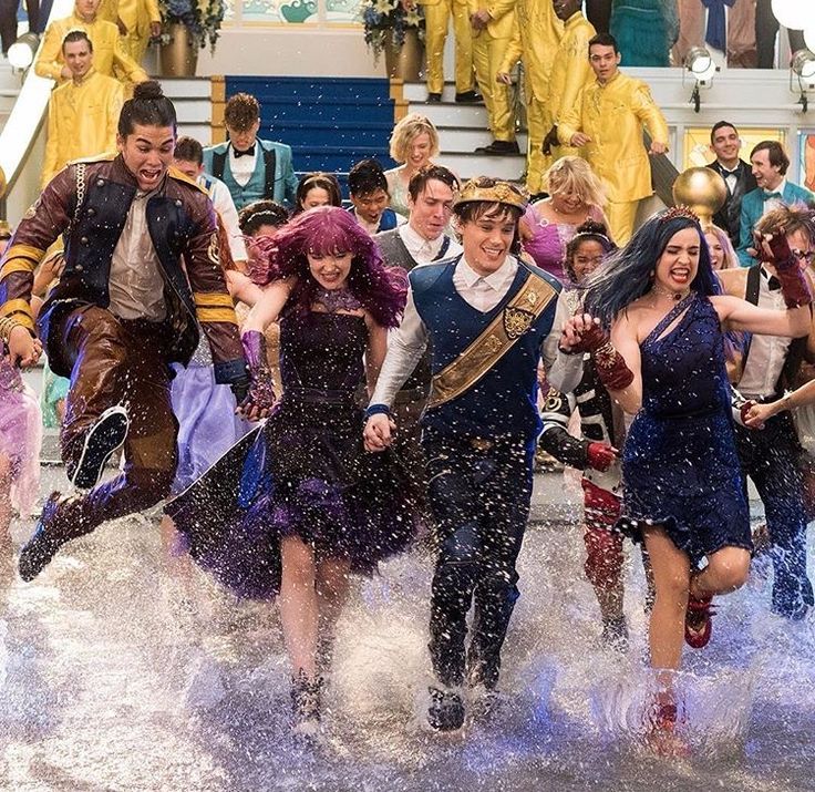 a group of people dressed in costumes running through the water on a boat with other people behind them