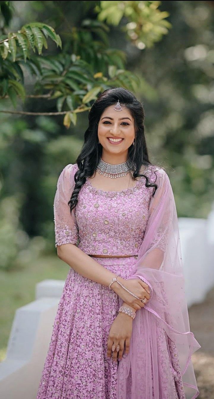 a woman in a pink dress posing for the camera