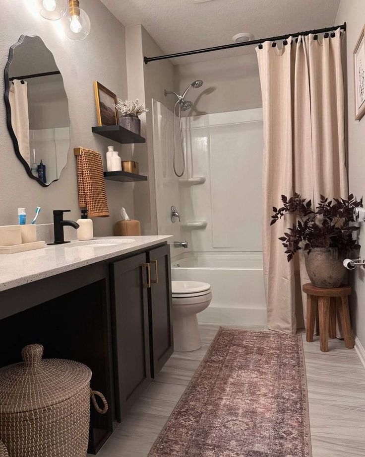 a bathroom with a sink, toilet and bathtub next to a shower curtain in it