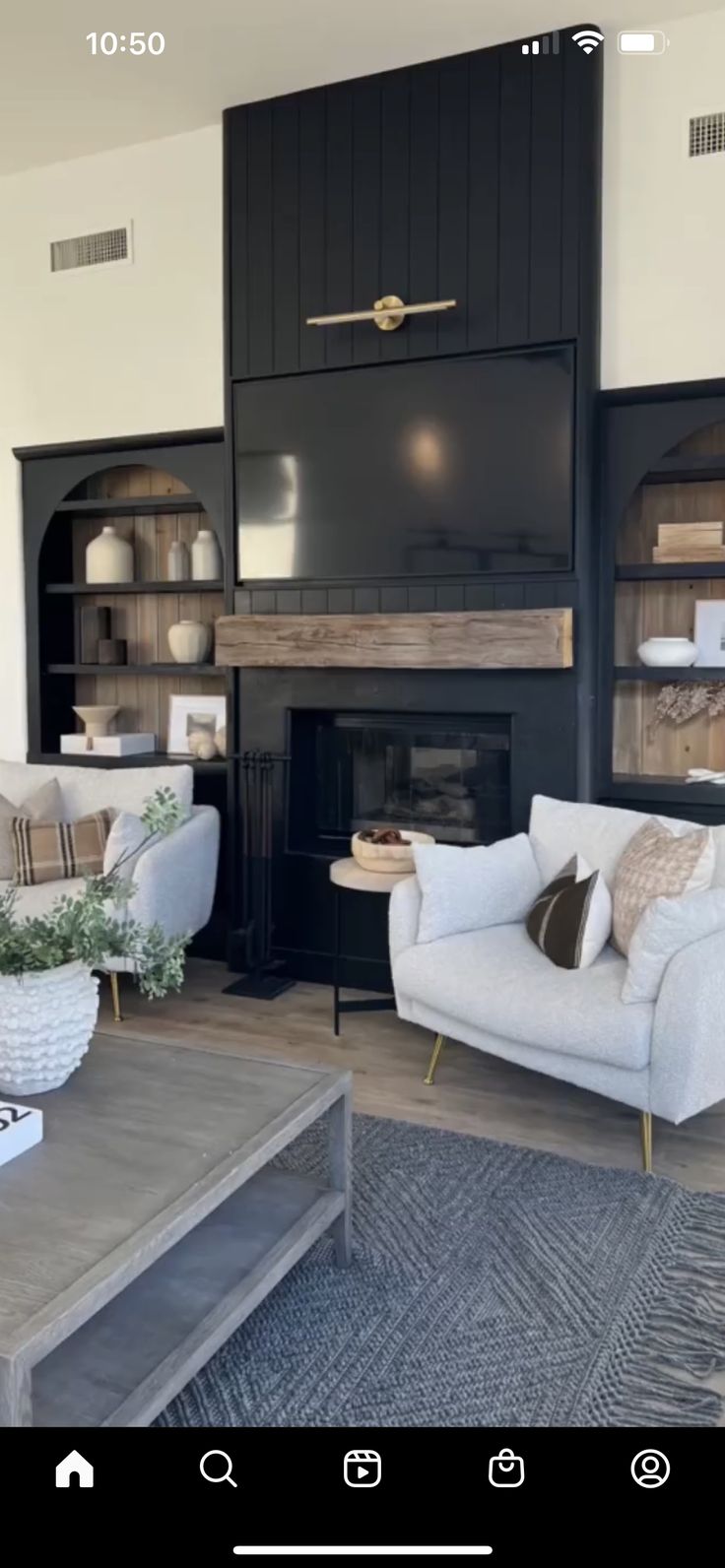 a living room filled with furniture and a fire place in front of a flat screen tv