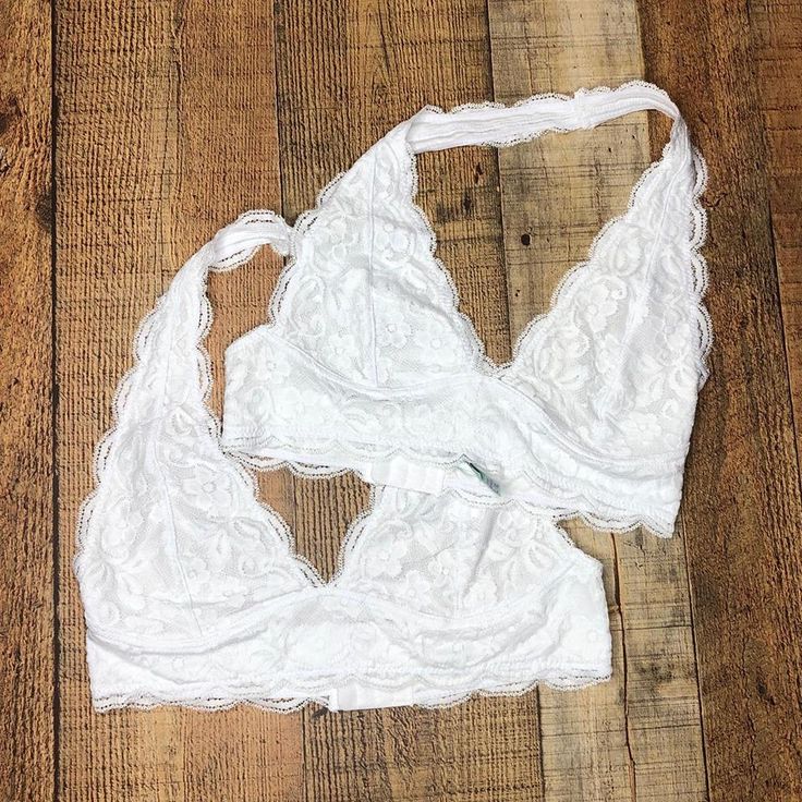 Our must-have Floral Lace Halter Bralette promises a feminine look and a comfy fit that's perfect for every day! The halter design makes it a great match for racerback tanks, shoulder-baring tops and deep-backed dresses S/M- 32a, 32b, 34a, 34b M/L- 34b, 34c, 36b, 36c L/XL- 34b, 34c, 34d, 36b XL/2X- 36c, 36d, 38b, 38c Stretch Racerback Halter Top, Spring Bra-friendly Tank Top With T-back, White Sleeveless Bra-friendly Halter Top, White Stretch Triangle Top Tank, White Seamless Racerback Halter Top, Spring T-back Top With Bra-friendly Design, Spring T-back Top With Bra Friendly Design, Spring Seamless Racerback Bra, Fitted Racerback Halter Top Bra Friendly