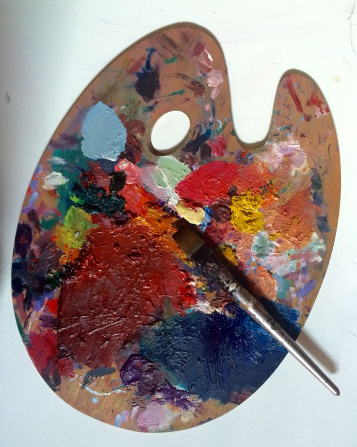 a paint palette with an artist's palette in the middle and a brush resting on it