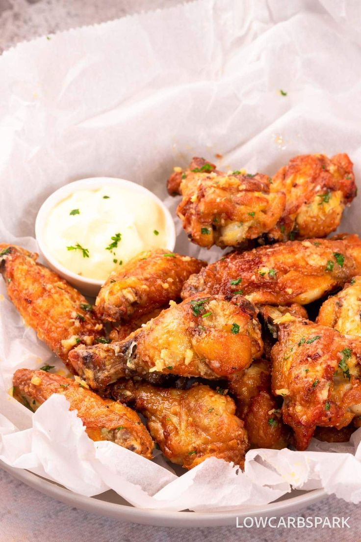 fried chicken wings with dipping sauce on the side