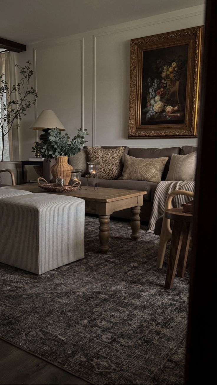 a living room filled with furniture and a painting on the wall