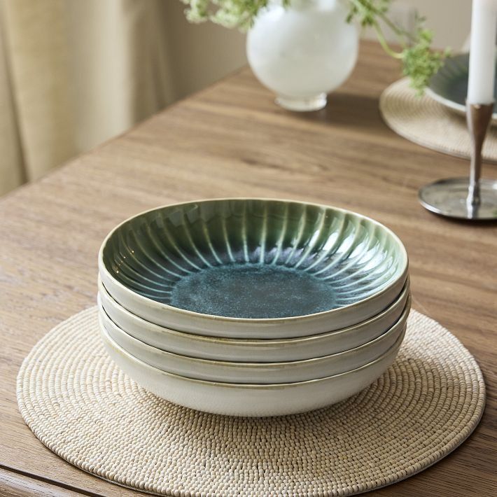 a stack of plates sitting on top of a wooden table