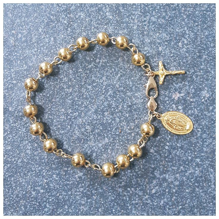 This bracelet has designed by Korea catholic person for her husband. She sugested all destails including cross and miraculous pendant. 24k gold 7mm ball has weaved by 18k solid gold wire of 0.9mm. For the safety reason, 18k gold clasp & 18k gold chain is used. * Material : 24K Solid gold & 18k solid gold *Total weight: about 24gram *24k gold crucifix : 18mm x 11mm *24k gold miraculous medal: 18mm x 11mm *Length: 7-7.5inch (adjustable) please put your actual wrist length then we will arra Yellow Gold Rosary Bracelet With Gold Beads As Gift, Spiritual Gold Rosary Bracelet With Gold Beads, Elegant Jewelry With Miraculous Medal And Round Beads, Gold Beaded Spiritual Rosary Bracelet, Dainty Handmade Gold Rosary Bracelet, Gold Rosary Bracelet With 8mm Beads, Spiritual Gold Rosary Bracelet, Hypoallergenic Gold Rosary Bracelet With Round Beads, Elegant Gold Plated Rosary Bracelet