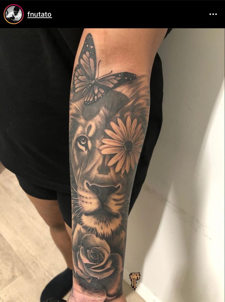 a woman's arm with a tiger and flowers on it