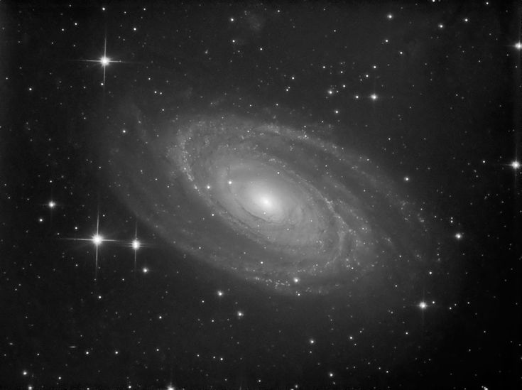 an image of a spiral galaxy in the sky with stars all around it and black and white background