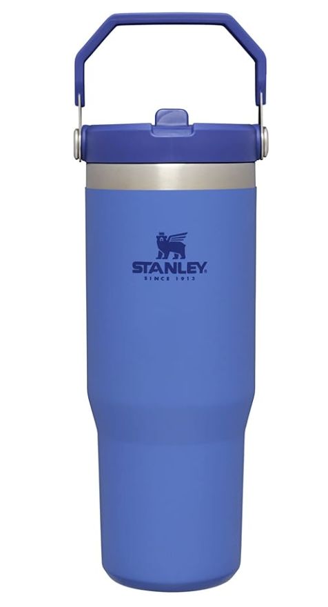 the stanley stainless steel insulated cup is blue and has a metal handle on it