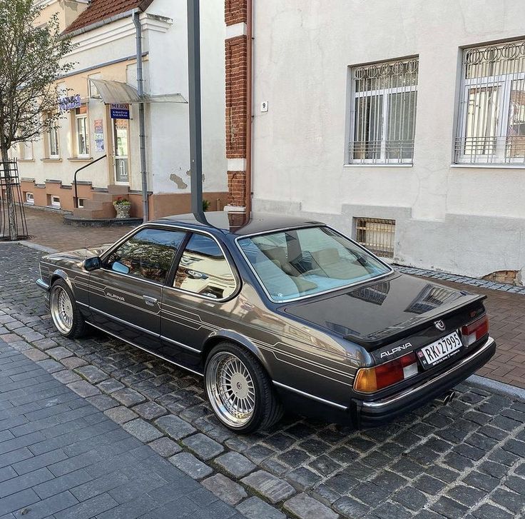 a black car parked on the side of a street