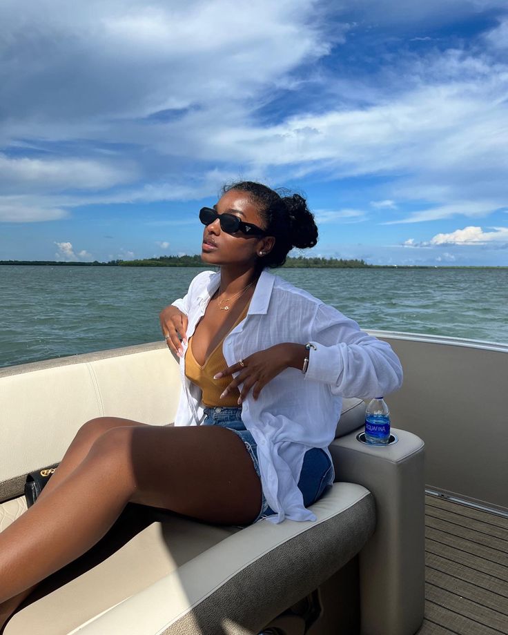 a woman sitting on the back of a boat