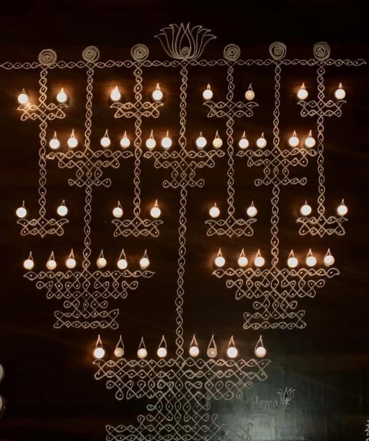 an intricate chandelier hanging from the ceiling in front of a window at night