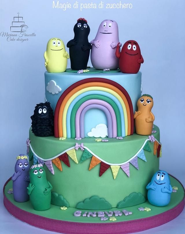 a multi layer cake decorated with cartoon characters