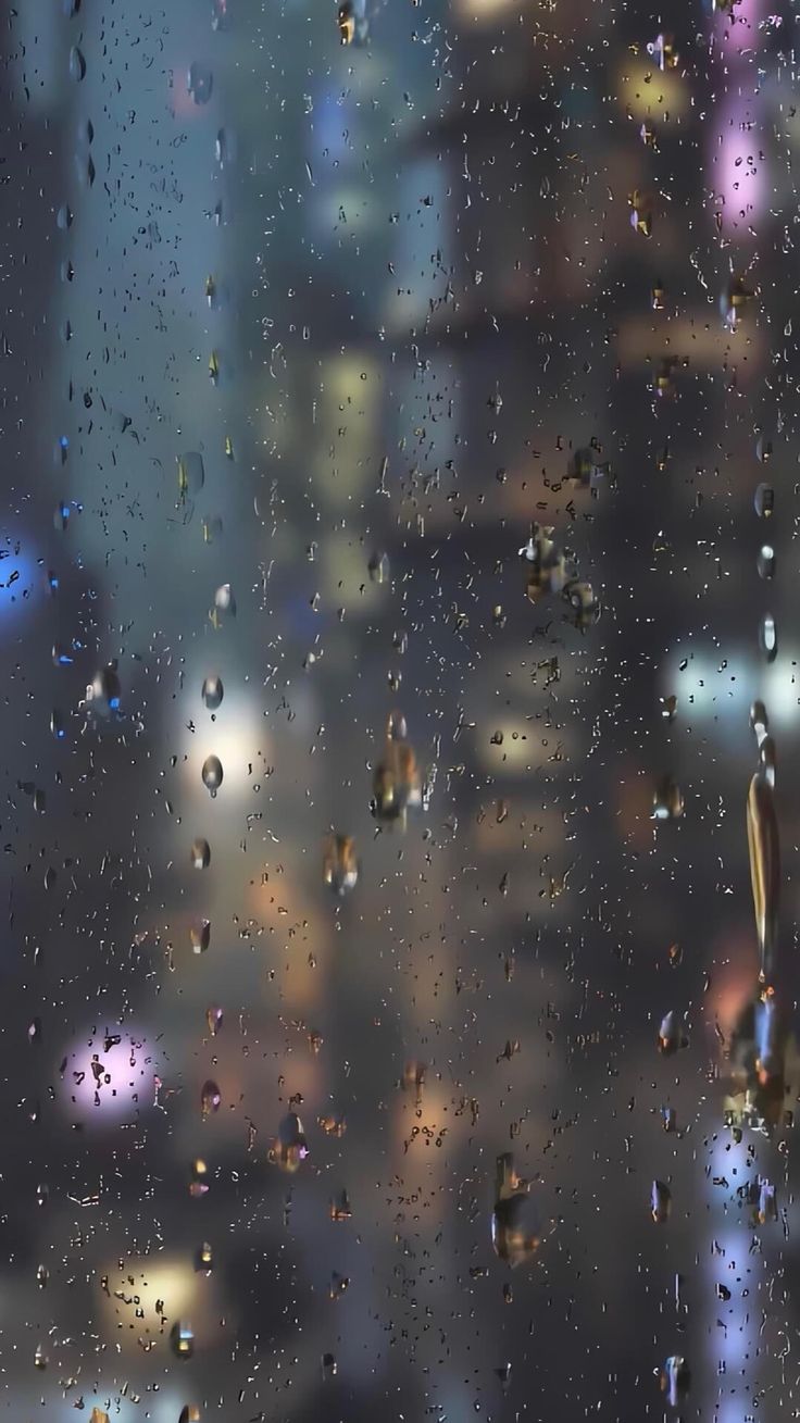 rain drops on the window with city lights in the background