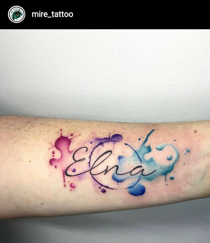 an arm tattoo with the word love written in watercolors on it and hearts