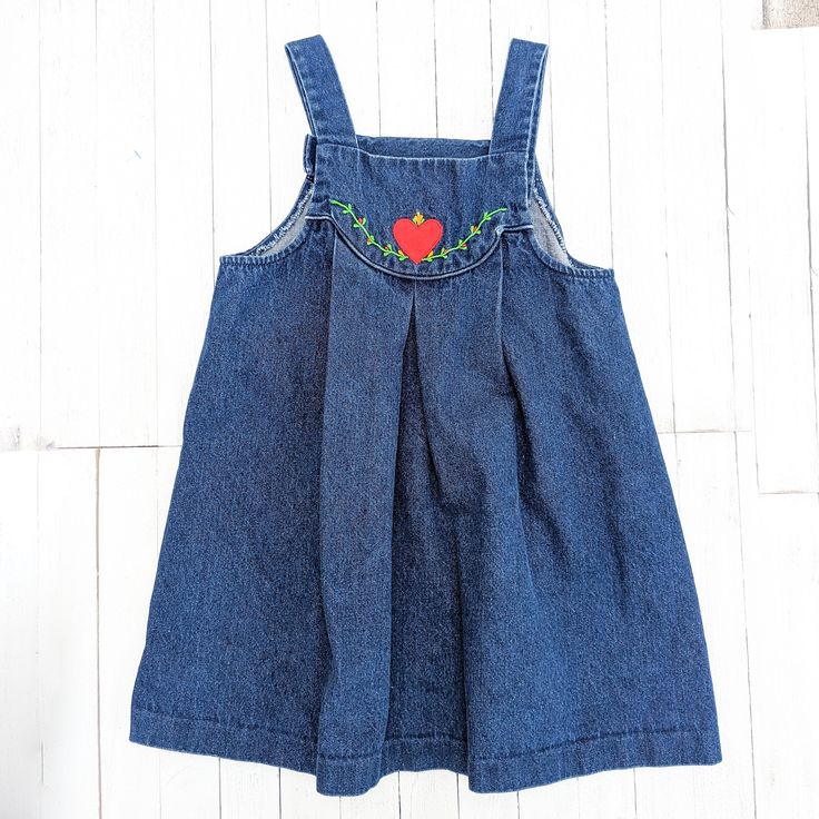 This Vintage Blue Jean Denim Overall Girl's Dress, is adorned with an endearing Heart Embroidery on the bib - a delightful piece from the Vintage Winnie the Pooh Brand that encapsulates the essence of nostalgia. This vintage girl's dress, tailored in size 6X, is a blend of retro charm and everyday practicality. Its blue jean denim composition brings a touch of timeless style, while the heart embroidery adds a whimsical touch.  Designed with attention to detail, this dress comes complete with the convenience of an overall-style design.  As with all our pieces, it's important to recognize that these items are pre-owned or vintage, carrying the stories of the past. This dress may bear signs of wear and tear, enhancing its vintage character. I encourage you to check the images thoughtfully pre Cute Medium Wash Sleeveless Dress, Cute Sleeveless Medium Wash Dress, Cute Denim Dress For Playdate, Medium Wash Embroidered Cotton Dress, Cute Medium Wash Denim Dress, Cute Cotton Denim Dress, Cute Cotton Denim Dress In Denim Blue, Cute Denim Blue Cotton Dress, Embroidered Medium Wash Cotton Denim Dress