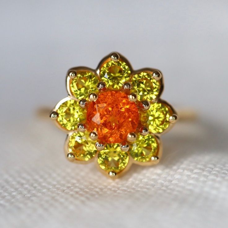 Neon Orange Fanta Garnet Yellow Sapphire Daisy Ring Orange Spessartite Garnet and Daisy Sapphire Cluster Ring Mandarine Garnet Made to Order Condition: Brand New & Custom Designed by me Size: Customizable  Metal: Solid 14K Yellow Gold Center Stone: Neon Orange Garnet Side Stones: Natural Yellow Sapphires 1.2ct Measurement: 15mm*15mm Certificate Included. 7-day return accepted. This item will be sent in well-made velvet jewelry box Please feel free to browse my shop for hundreds of additional pie Orange Diamond Wedding Ring Fine Jewelry, Orange Garnet Ring, Mandarin Garnet Ring, Orange Sapphire Jewelry, Orange Multi-stone Ring Jewelry, Orange Gemstone-accented Ring Jewelry, Sapphire Halo Ring, Spinel Jewelry, Spessartite Garnet