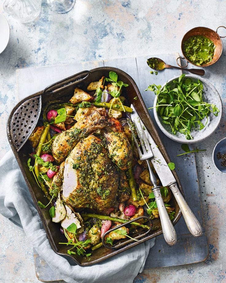 a roasting pan filled with chicken and vegetables