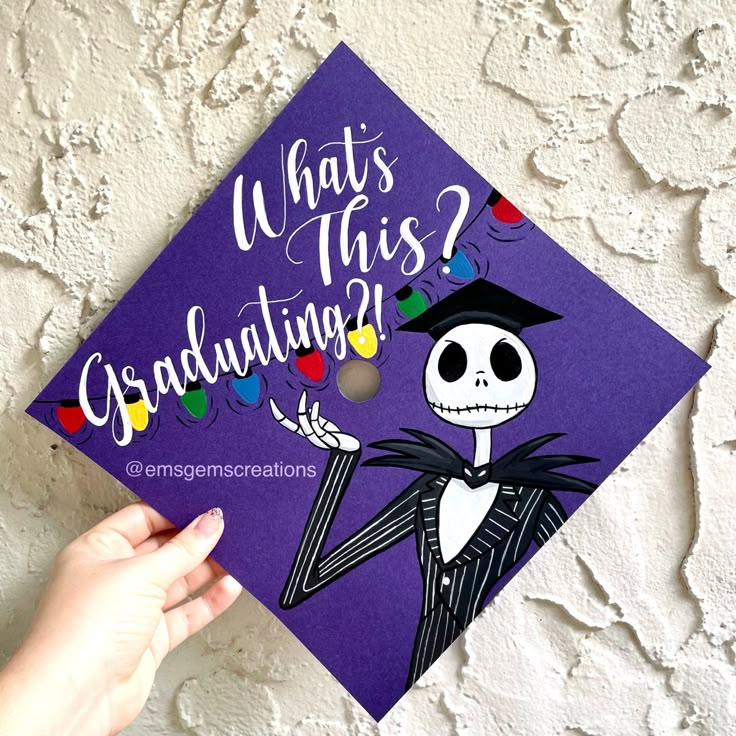 someone holding up a purple graduation cap that says, what's this graduating?