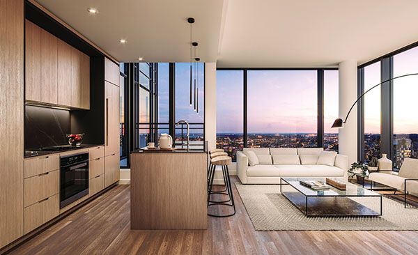 a living room filled with furniture and large windows overlooking the city at sunset or dawn