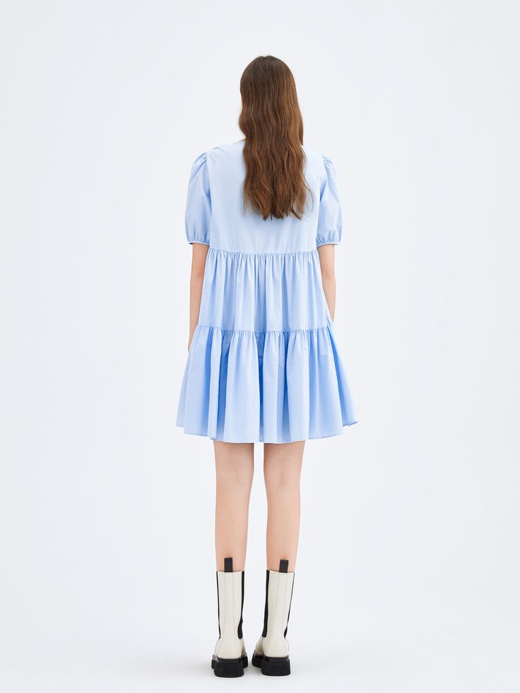 Details: Refined soft fabric. Loose fit. Puffed sleeve. Materials & Care: 100% Cotton Machine wash | Gentle dry clean Do not bleach Size & Fit: Model is 5'8", Bust 30, Waist 24, Hips 36, wearing a size S Item #: LK2DR206B Blue Cotton Tiered Dress With Ruffle Hem, Spring Blue Tiered Dress, Blue Tiered Dress For Spring, Spring Blue Tiered Dress With Tiered Skirt, Spring Blue Cotton Tiered Dress, Blue Cotton Tiered Dress For Spring, Blue Short Sleeve Tiered Dress For Spring, Light Blue Tiered Skirt Dress, Blue Mini Length Tiered Dress For Spring