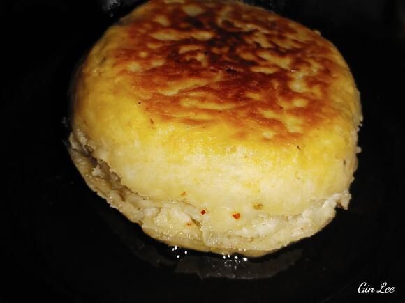 a close up of a food item in a pan on top of a stove burner