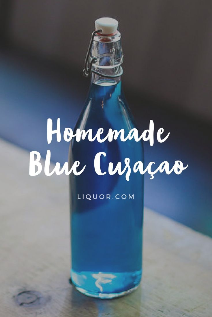 a blue glass bottle with the words homemade blue curacao in white lettering on it