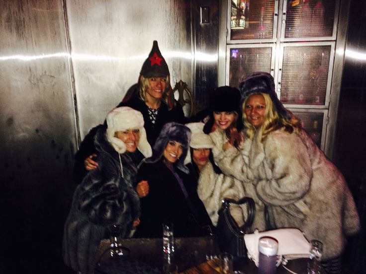 group of women in fur coats posing for the camera