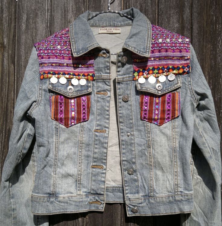 a denim jacket with buttons and beads on it