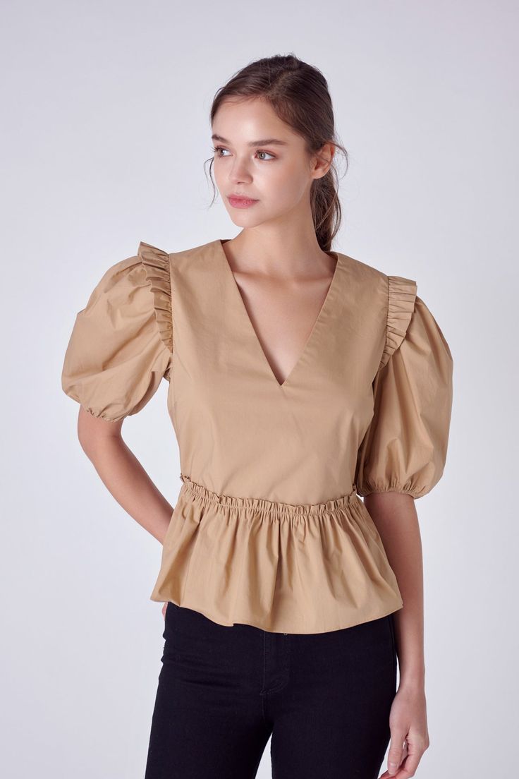 This V-neck Puff Sleeve Top is perfect for making a statement. Featuring ruffled shoulders and elasticated puffed short sleeves, you'll love showing off its peplum waist. With its unique styling and comfortable fit, this top is sure to become a favourite in your wardrobe. Make an impression and look your best with this must-have top. V-neck Puffy short sleeves with elastic armholes Ruffled shoulders Peplum hem Concealed side zipper Lined bodice Hand wash cold Do not bleach Do not tumble dry Iron low Shell: 100% Cotton Contrast: 100% Cotton Exclusive of Elastic JJ2073T Total length :22.50" Bust :36" S WHITE, BLACK: Height 5'10" / Bust 33" / Waist 24.5" / Hip 35" TAN: Height 5'9" / Bust 33.5" / Waist 23" / Hip 34.5" Spring V-neck Puff Sleeve Top With Ruffles, Chic V-neck Peplum Top With Ruffles, Fitted Puff Sleeve Top With Elastic Shoulders, Chic Puff Sleeve Tops With Elastic Shoulders, Solid Color Puff Sleeve Top With Gathered Sleeves, Solid Puff Sleeve Top With Gathered Sleeves, Puff Sleeve Top With Gathered Short Sleeves, V-neck Puff Sleeve Top With Elastic Sleeves For Spring, Feminine Puff Sleeve Top With Ruffles V-neck