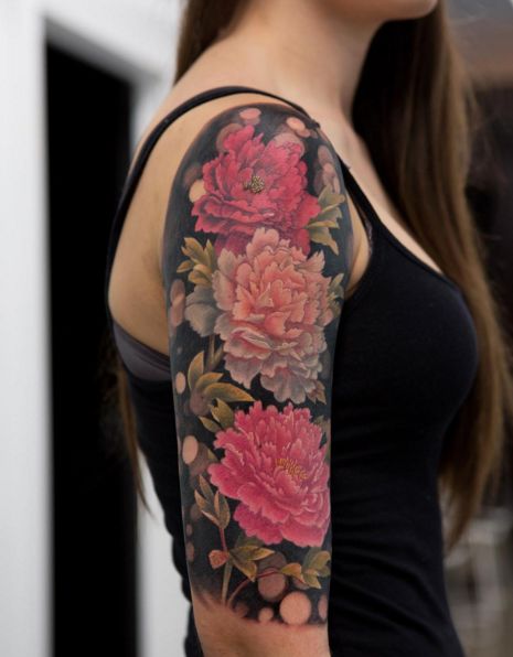 a woman with a flower tattoo on her arm