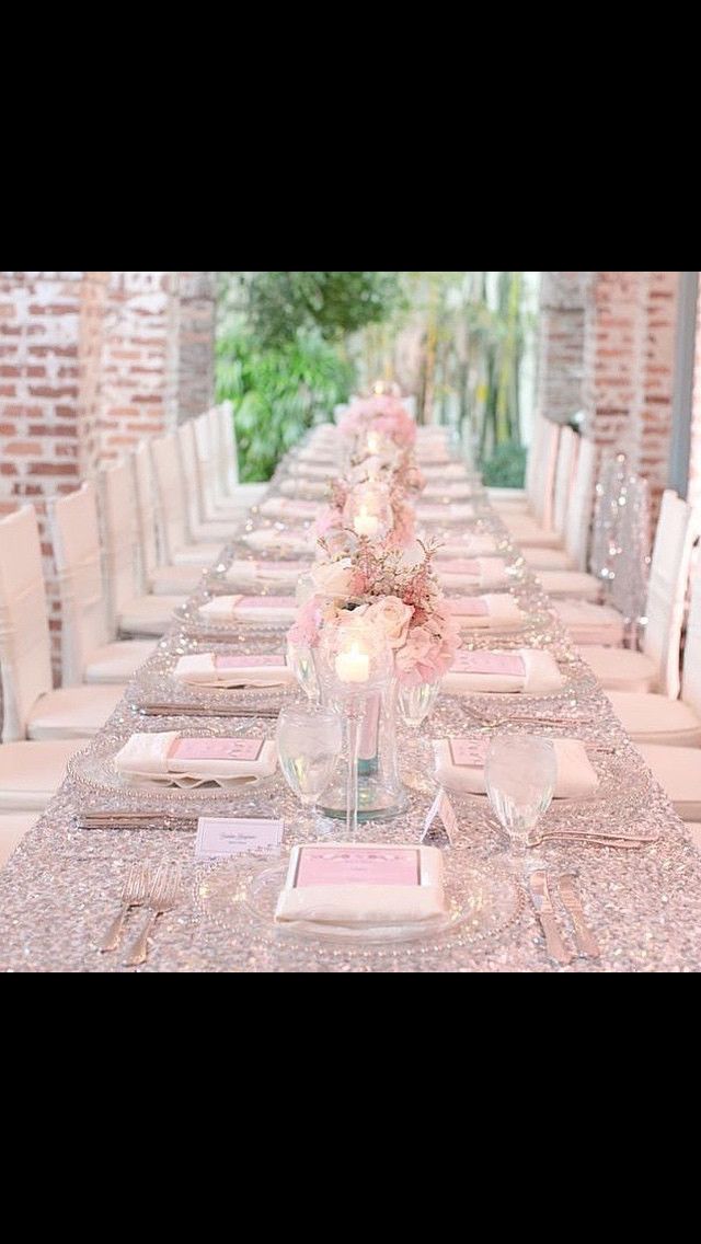 the table is set with pink flowers and place settings for an elegant dinner or bridal party