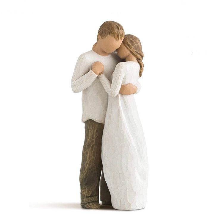 a figurine of two people hugging each other