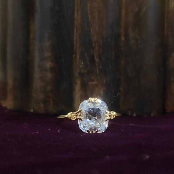 a close up of a ring on a velvet surface