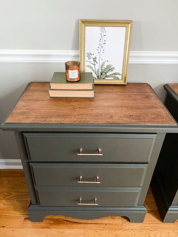 two nightstands with books and a candle on top of them next to each other