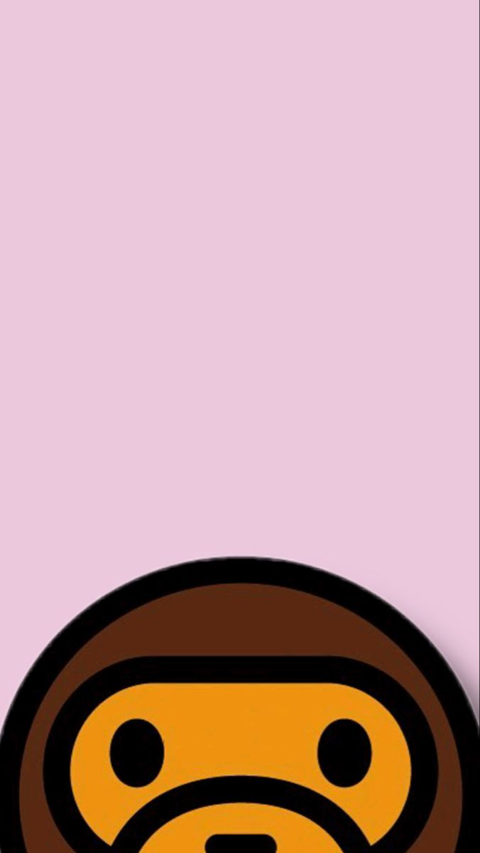 a brown and black monkey face on a pink background