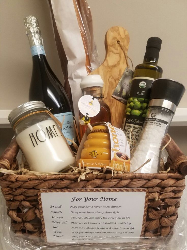 a basket filled with wine, condiments and other items on a counter top