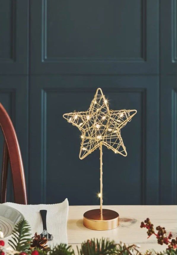 a christmas tree topper on a dining room table