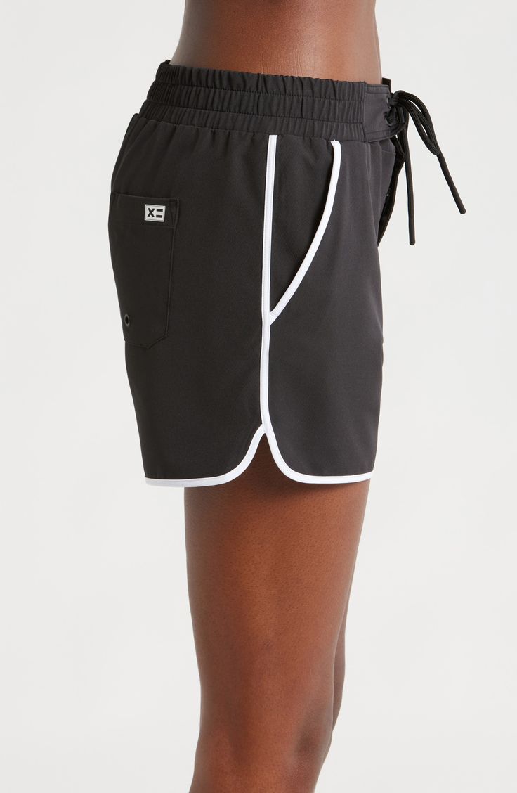 A '90s-inspired lace-up closure and dolphin hem bring some extra fun to these stretchy, high waist board shorts featuring built-in sun protection for the win. 2 1/2" inseam Zip fly with snap closure; lace-up closure Front slant pockets; back patch pocket with drainage grommet UPF 50+ sun protection 92% recycled polyester, 8% spandex Machine wash, tumble dry Imported Black Athletic Shorts With Built-in Shorts For Summer, Sporty Shorts With Built-in Shorts For Vacation, Black Swimwear With Built-in Shorts, Sporty Swim Trunks With Built-in Shorts For Summer, Nylon Bottoms With Built-in Shorts For Beach Season, Sporty Black Swimwear With Built-in Shorts, Casual High-waisted Swim Shorts For Poolside, High Waist Sports Bottoms With Drawstring, Black Sports Bottoms For Summer