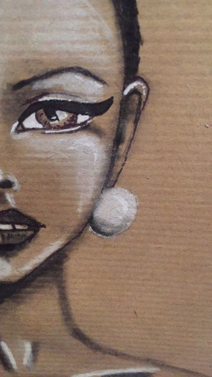 a drawing of a woman's face painted on wood