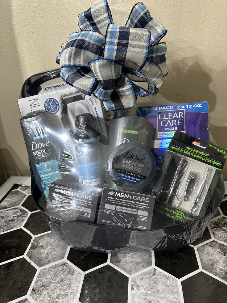 a gift basket with men's care products on top of a tiled countertop