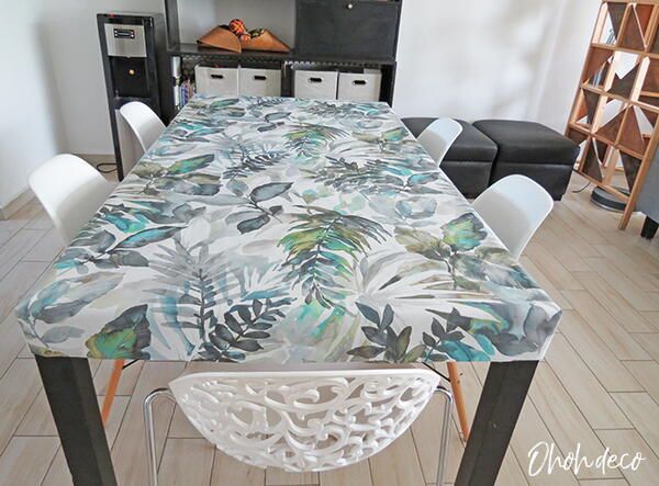 a dining room table covered in a tropical print