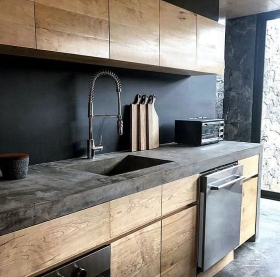 a kitchen with black walls and wooden cabinets