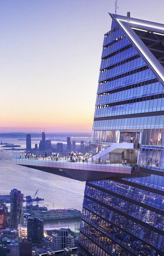 an aerial view of the top of a skyscraper building in new york city at sunset