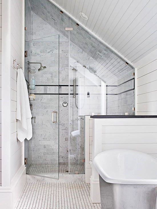 a bathroom with a tub, sink and shower