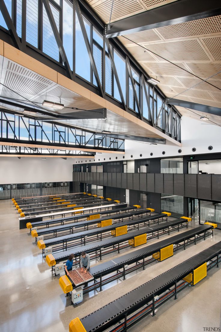 the inside of an empty building with benches and railings