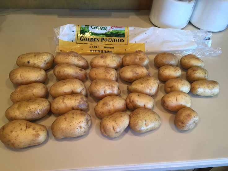 potatoes are laid out on a counter top next to a bag of golden potato chips