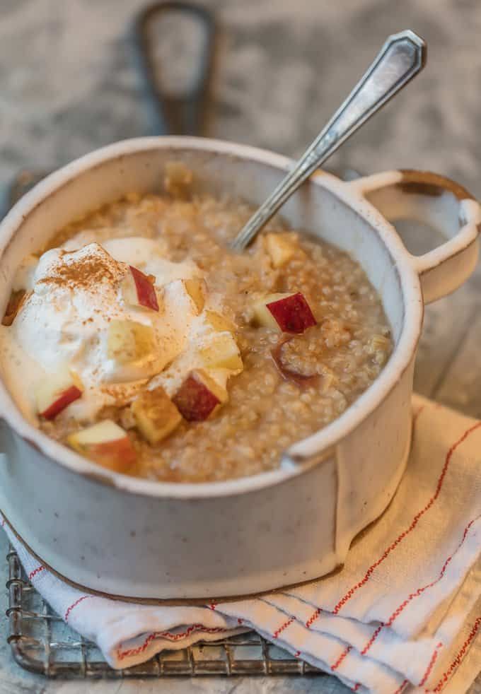 a bowl of oatmeal with apples and an egg on top