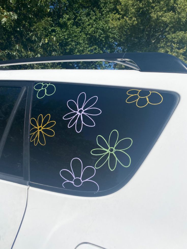 a car with flowers painted on it's side window