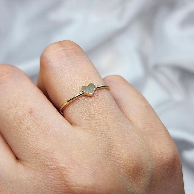 14K Solid Gold Dainty Heart Promise Ring for Her 🌟 Product Features: ⚖️ Weight: 1.05 Grams 🌈 Material Colors: Available in Yellow Gold, Rose Gold, and White Gold 🎁 Presentation: Shipped with a special box and bag, perfect for gifting 🔄 Returns: Right to return within 7 days ✨ Material and Color: Designed to never fade or darken 🛠️ Handcraftsmanship and Uniqueness: Handcrafted with love, may vary by 5% (+-) Give a heartfelt token of love with the 14K Solid Gold Dainty Heart Promise Ring. Thi Minimalist Heart Ring With Simple Design, Simple Heart Ring For Valentine's Day, Simple Heart-shaped Stackable Promise Rings, Dainty Heart-shaped Stackable Rings As Gift, Dainty Heart-shaped Stackable Rings For Gifts, Dainty Gold Heart Ring For Promise, Dainty Heart Ring With Simple Design For Promise, Dainty Tiny Heart Ring For Valentine's Day, Minimalist Heart-shaped Ring With Simple Design